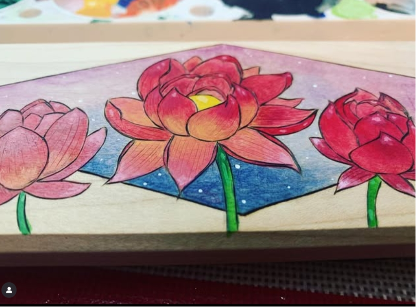 Colorful lotus flower drawing on a wooden board